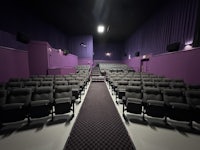 a purple theater with rows of seats