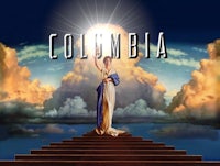 the cover of columbia, with a woman standing on top of stairs
