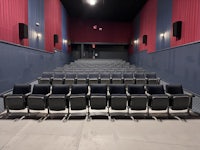 an empty movie theater with rows of seats