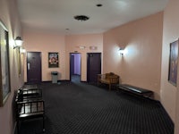 a hallway with purple walls and a bench