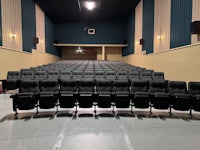 an empty auditorium with rows of seats